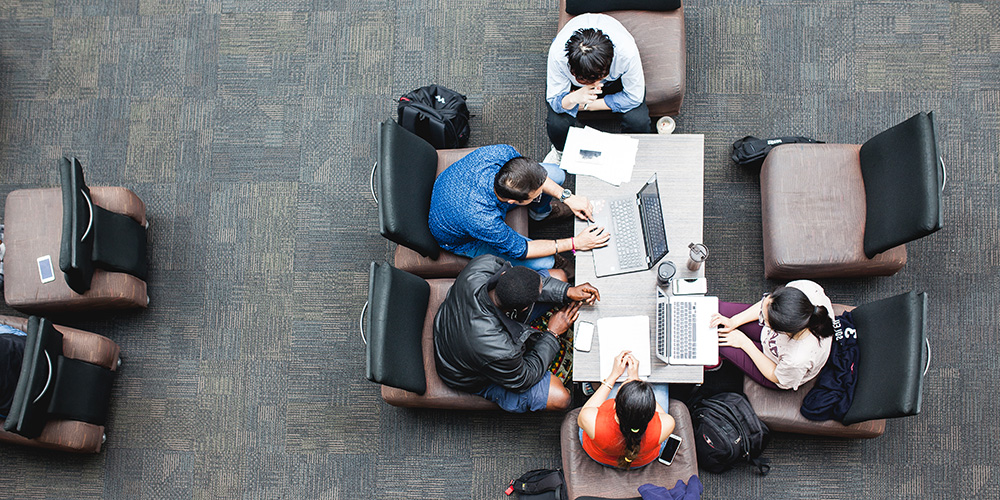 A shot from above of students working together at a table.