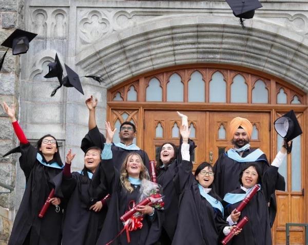 Students who have graduated and are throwing their caps in the air