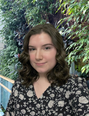 A student posing for a picture with a nature background