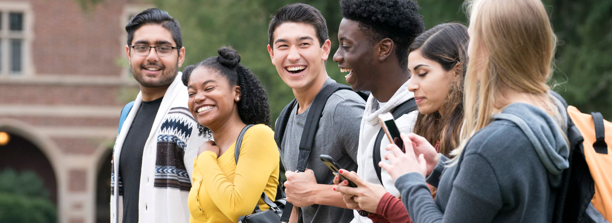 A row of students walking and smiling