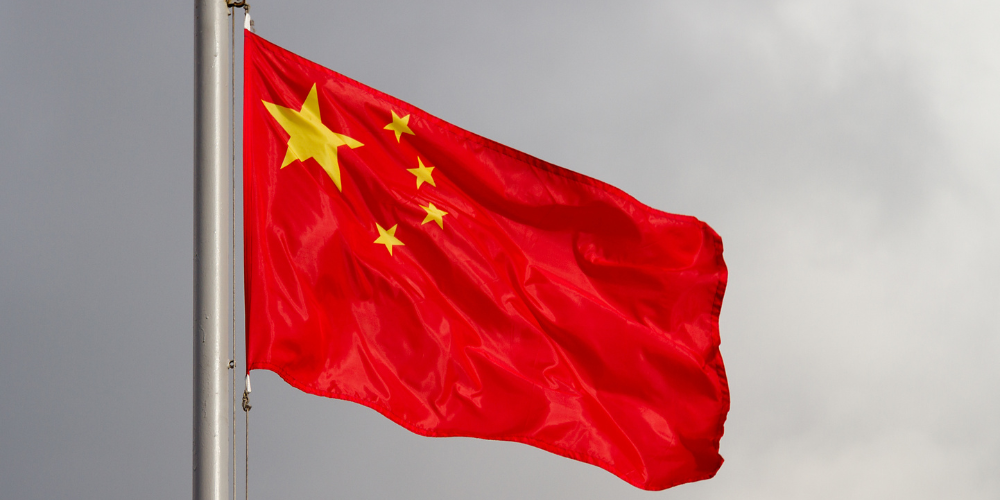 The flag of China waves on a flagpole